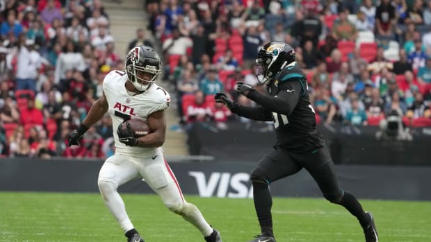 Oct 1, 2023; London, United Kingdom; Atlanta Falcons running back Bijan Robinson (7) carries the ball against Jacksonville Jaguars cornerback Darious Williams (31) in the second half during an NFL International Series game at Wembley Stadium.